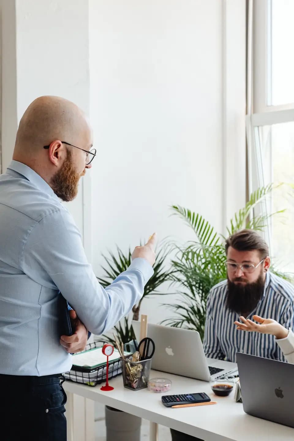 Two colleagues talking through a problem in an office