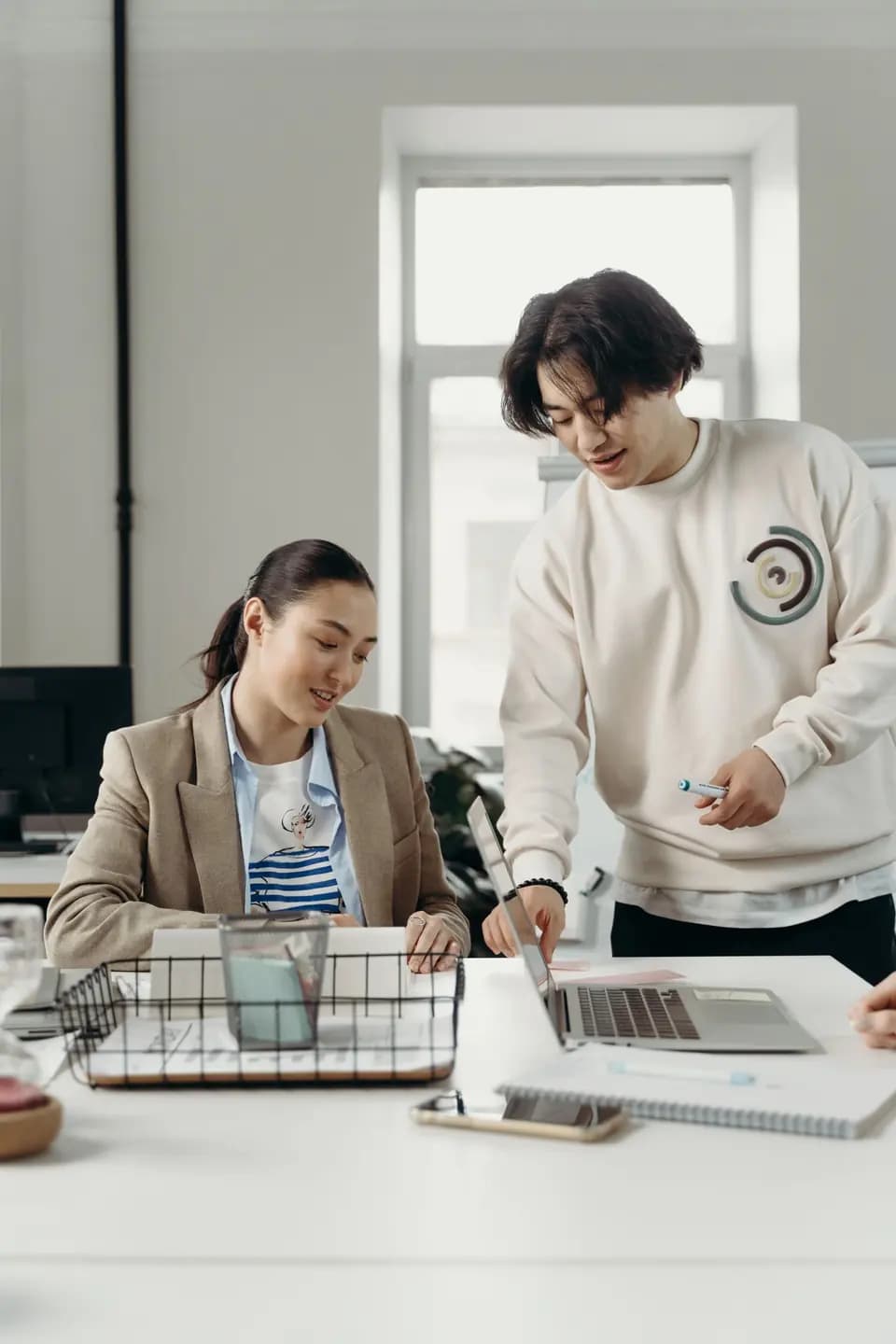 Colleagues planning a piece of work together in an office