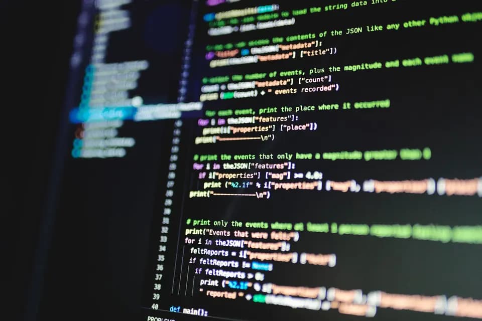 Source code on a dark monitor in a low-lit room