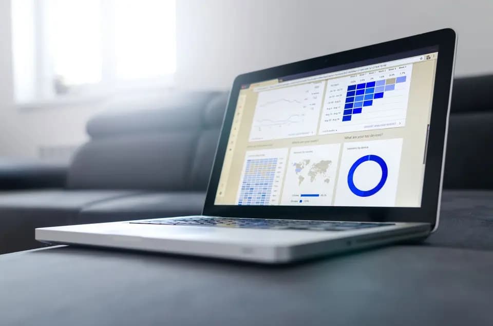 A laptop screen filled with charts and figures