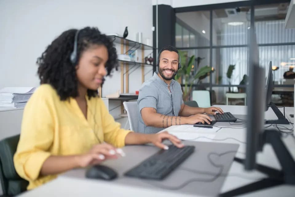 Two support engineers working at adjacent computers